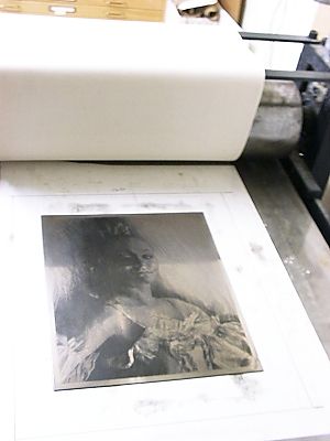 the inked plate on the press bed